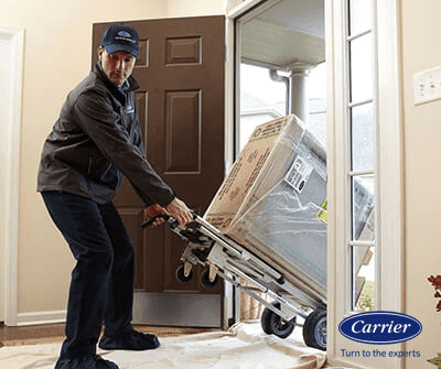 man pulling the new AC unit