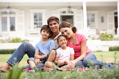 Happy family sitting on the grass