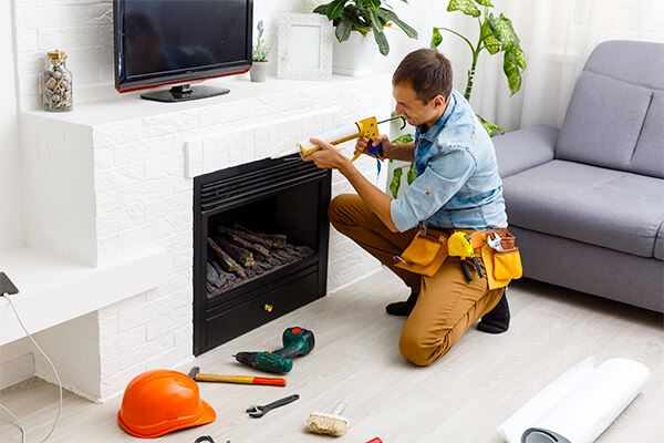 Technician repairing fireplace